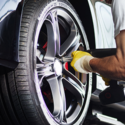 Automobile computer diagnosis. Car mechanic repairer looks for engine failure on diagnostics equipment in vehicle service workshop